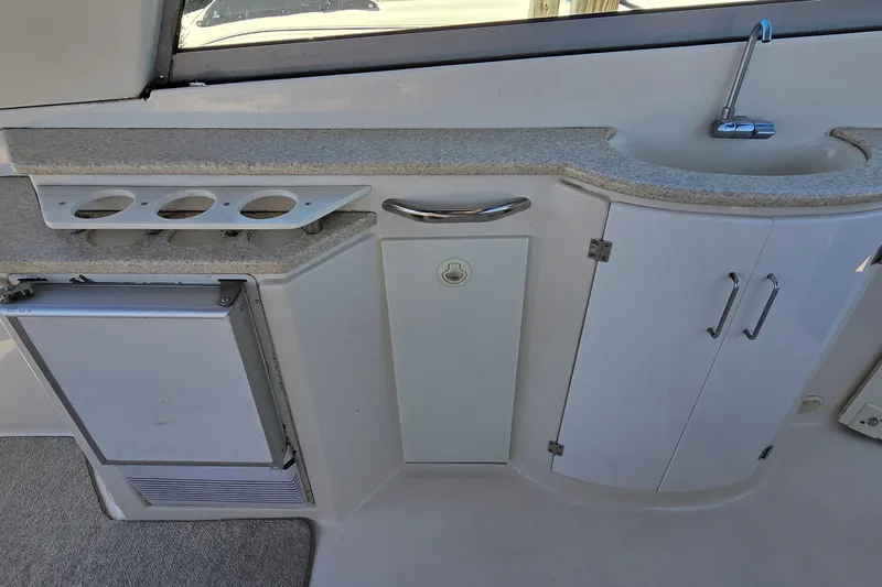 Slide: The Image of 2001 Monterey 322 Cruiser interior with sink, storage cabinets, and cup holders. - 14