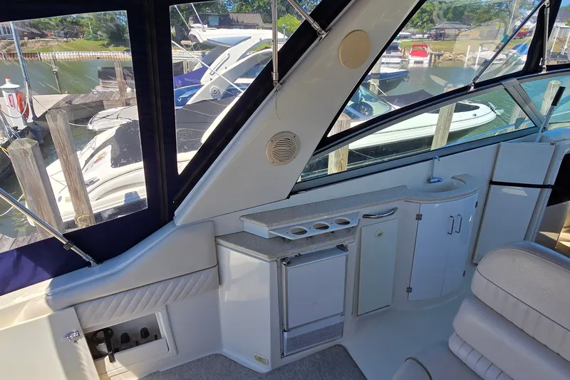 Slide: The Image of Interior of a 2001 Monterey 322 Cruiser yacht with kitchenette and seating area. - 9