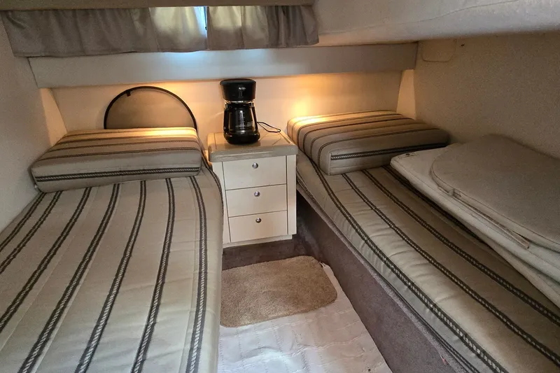 Slide: The Image of 2001 Monterey 322 Cruiser cabin with twin beds and a coffee maker. - 24