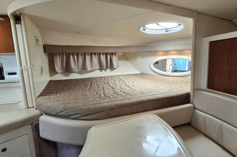 Slide: The Image of Interior cabin of a 2001 Monterey 322 Cruiser with a cozy bed and seating area. - 19