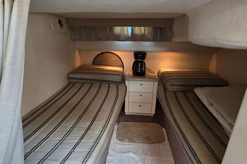 Slide: The Image of Interior of a 2001 Monterey 322 Cruiser with twin beds and a coffee maker. - 23