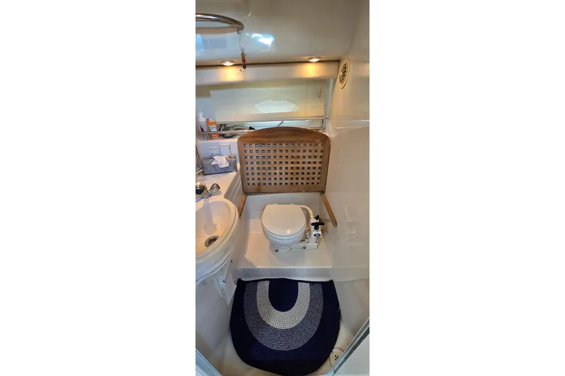 Slide: The Image of Bathroom interior of 2001 Monterey 322 Cruiser with sink, toilet, and nautical decor. - 27