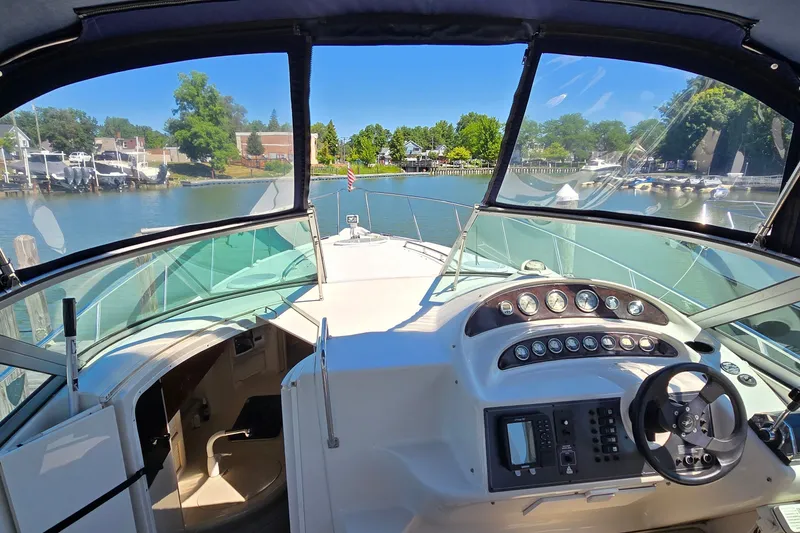 Slide: The Image of Cockpit view of 2001 Monterey 322 Cruiser boat, docked in a scenic marina. - 15