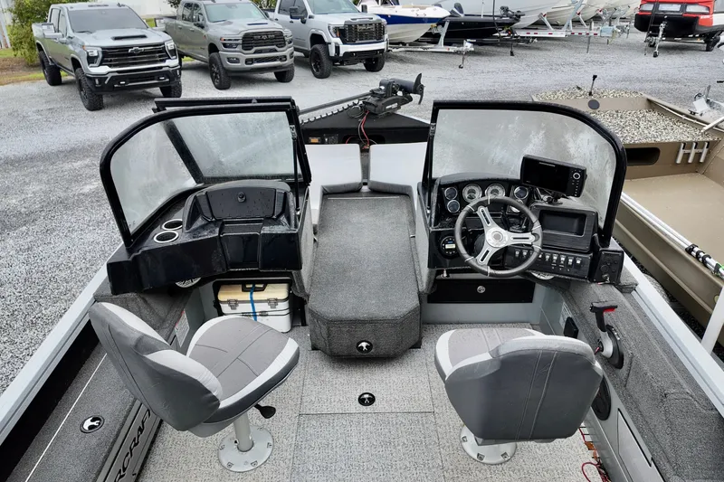 Slide: The Image of Interior of a 2023 Starcraft Delta 188 DC Pro boat with modern controls and seating. - 2