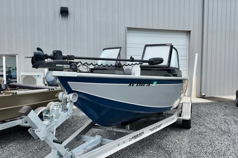 Slide: The Image of 2023 Starcraft Delta 188 DC Pro boat on trailer, parked outside a metal building. - 11