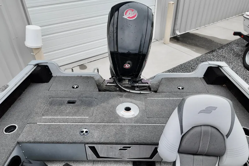 Slide: The Image of 2023 Starcraft Delta 188 DC Pro boat interior with motor and seating. - 4