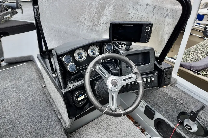 Slide: The Image of 2023 Starcraft Delta 188 DC Pro boat dashboard with steering wheel and electronic display. - 6