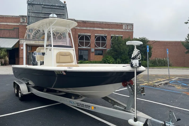 Slide: The Image of 2017 Nautistar 227 XTS boat on trailer, parked outside a brick building. - 1