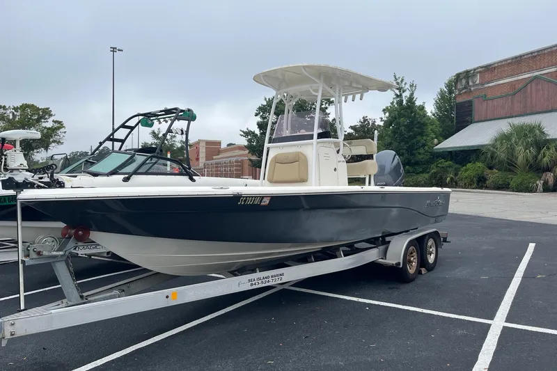 The Image of 2017 Nautistar 227 XTS boat on trailer in parking lot, overcast sky. - 0