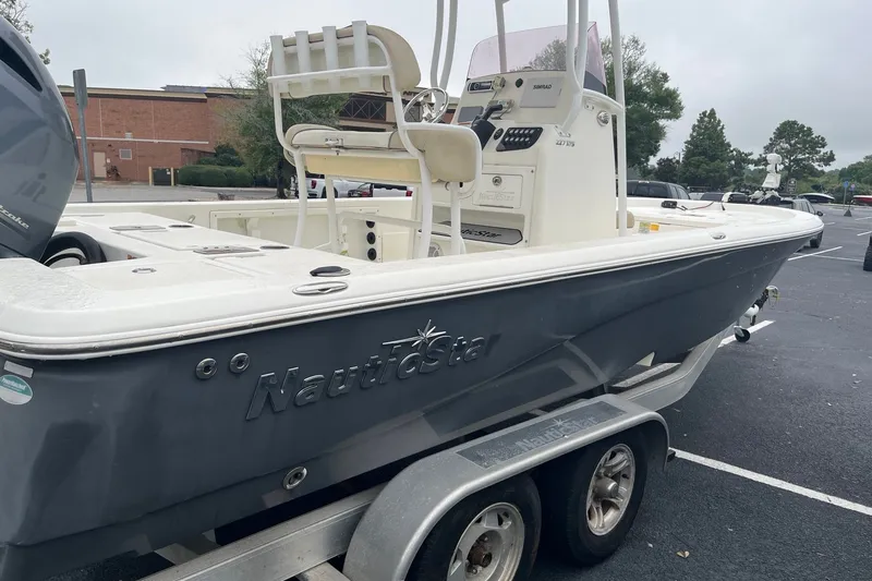 Slide: The Image of 2017 Nautistar 227 XTS boat on trailer in parking lot. - 2