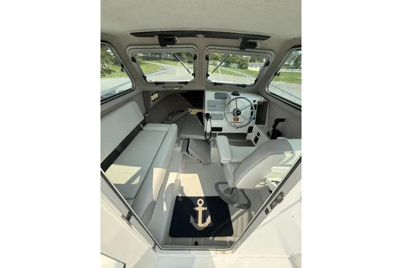 Slide: The Image of Interior of 2021 Parker 2120 Sport Cabin boat with steering wheel and seating. - 4