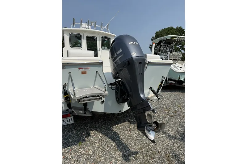 Slide: The Image of 2021 Parker 2120 Sport Cabin boat with Yamaha 200 outboard motor, rear view. - 12