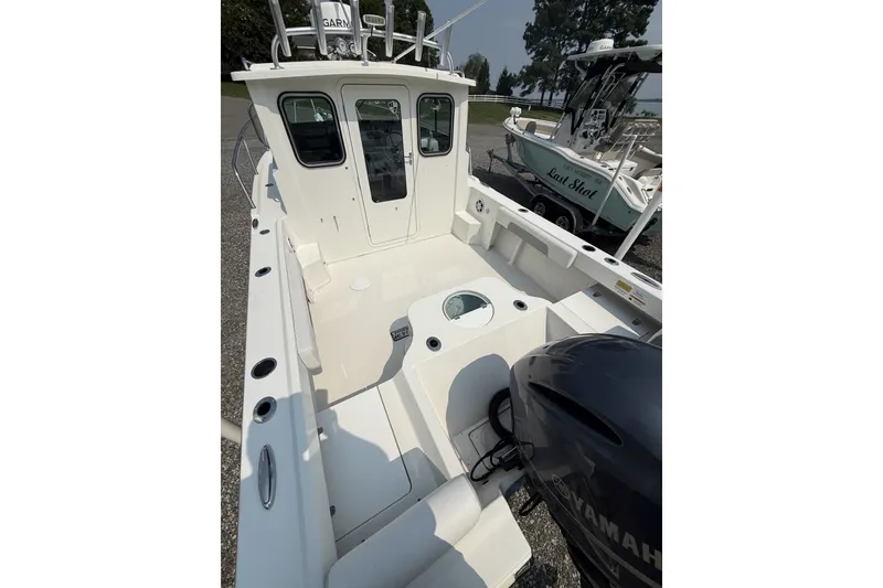 Slide: The Image of 2021 Parker 2120 Sport Cabin boat with Yamaha engine, featuring spacious deck and cabin. - 2