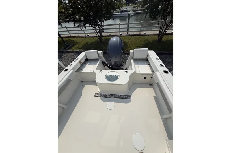 Slide: The Image of 2021 Parker 2120 Sport Cabin boat deck with outboard motor, dockside view. - 3