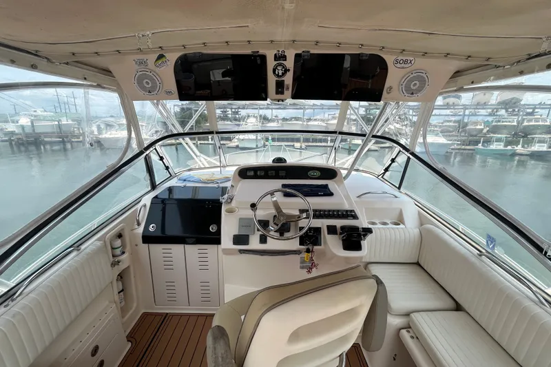 Slide: The Image of 2005 Grady-White Express 330 helm with modern controls and panoramic marina view. - 9