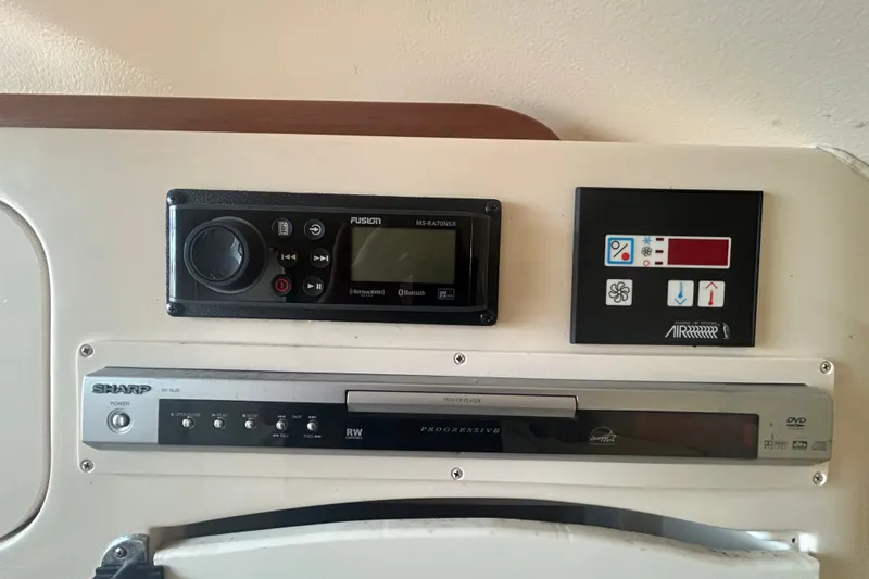 Slide: The Image of Control panel of a 2005 Grady-White Express 330 boat with audio and climate controls. - 17