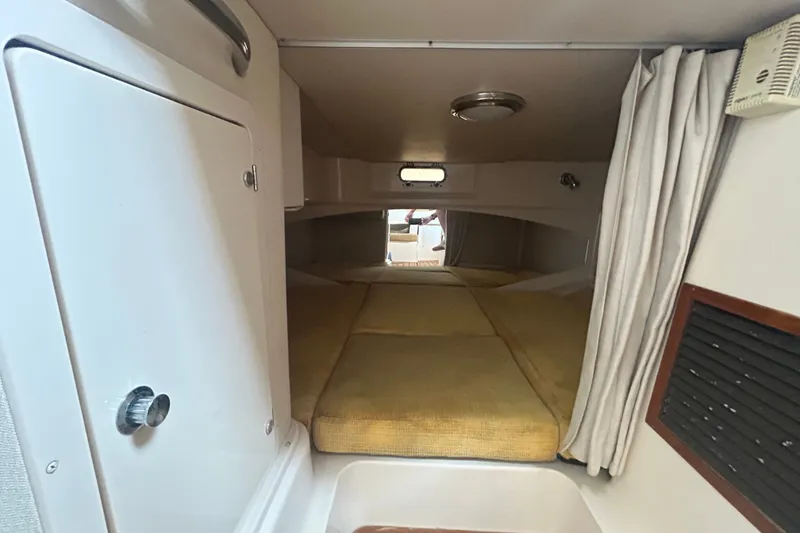Slide: The Image of 2005 Grady-White Express 330 cabin interior with cozy sleeping area and storage. - 25