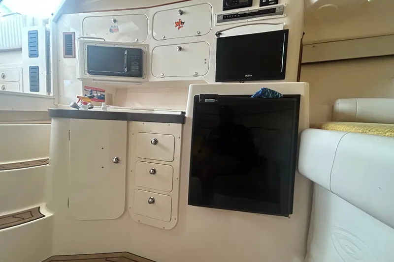 Slide: The Image of 2005 Grady-White Express 330 cabin interior with kitchenette and storage cabinets. - 16