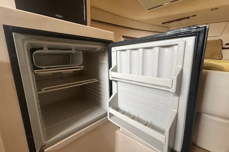 Slide: The Image of Open refrigerator inside a 2005 Grady-White Express 330 boat cabin. - 21