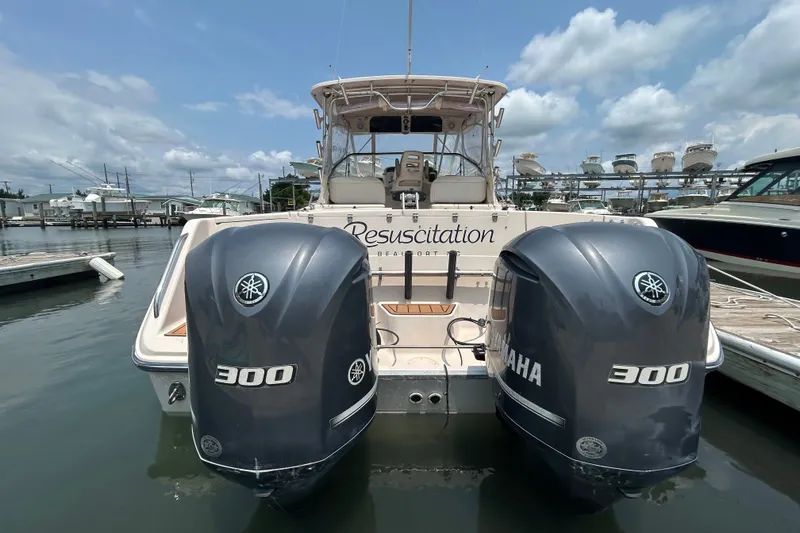 Slide: The Image of 2005 Grady-White Express 330 boat with twin Yamaha 300 engines docked at marina. - 1