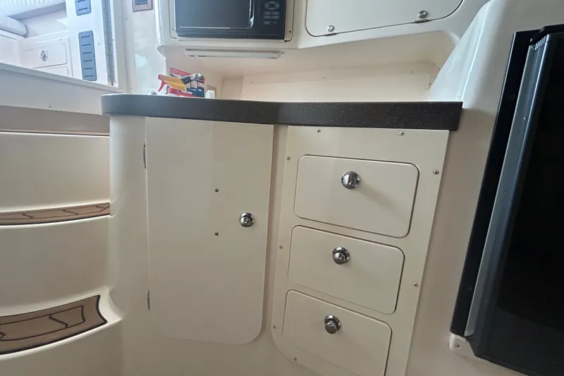 Slide: The Image of 2005 Grady-White Express 330 interior with storage drawers and countertop. - 22