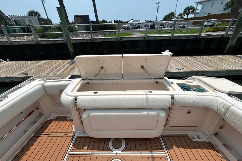 Slide: The Image of 2005 Grady-White Express 330 boat interior with open storage compartment at dock. - 3