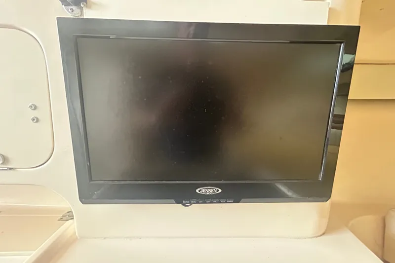 Slide: The Image of Jensen TV screen on 2005 Grady-White Express 330 boat interior. - 18