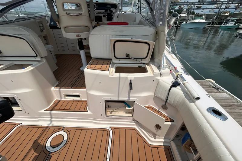 Slide: The Image of 2005 Grady-White Express 330 boat interior with teak flooring and open storage compartments. - 8