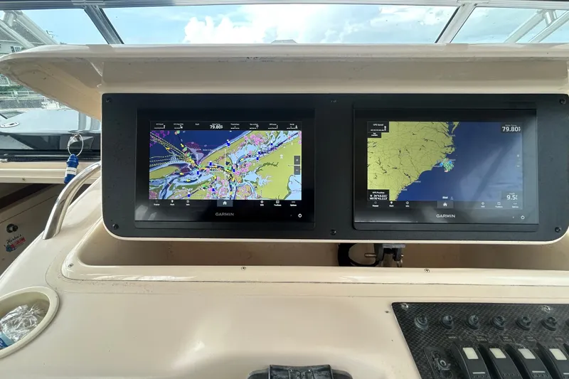 Slide: The Image of 2005 Grady-White Express 330 boat with dual Garmin navigation screens displaying maps. - 31