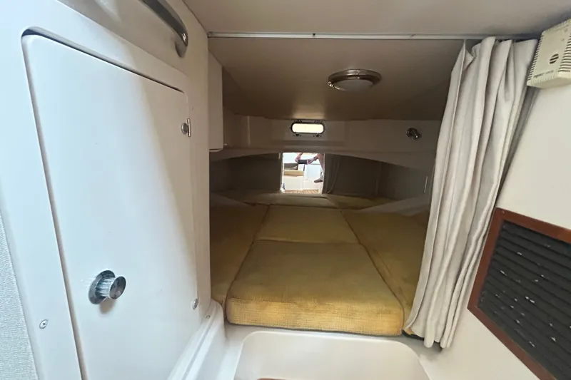 Slide: The Image of Interior cabin of 2005 Grady-White Express 330 boat with yellow cushions and curtains. - 24