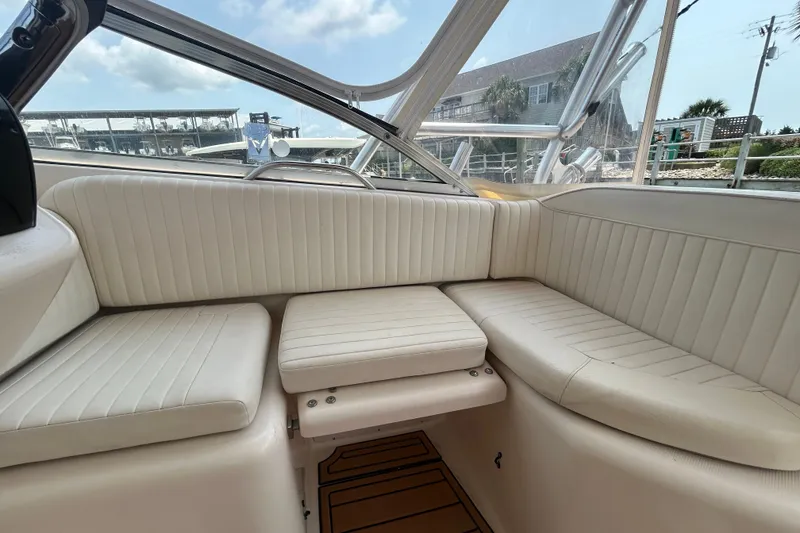 Slide: The Image of 2005 Grady-White Express 330 boat interior with white cushioned seating. - 11