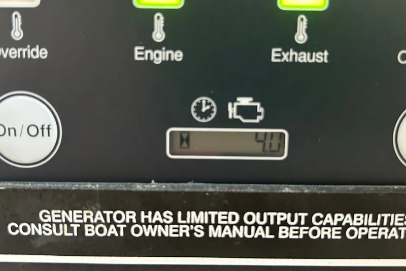 Slide: The Image of Control panel of a 2005 Grady-White Express 330 boat, showing engine and exhaust indicators. - 28