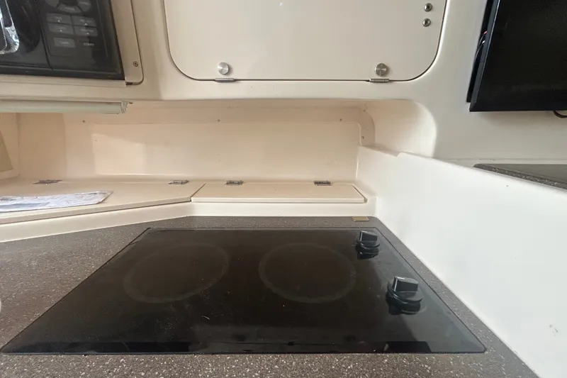 Slide: The Image of 2005 Grady-White Express 330 boat kitchen with stovetop and storage cabinets. - 20