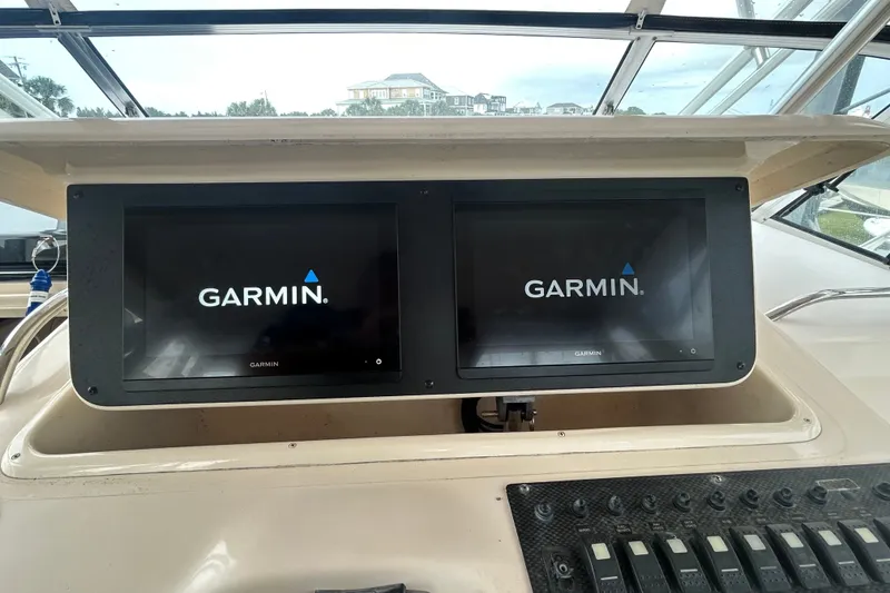Slide: The Image of Dual Garmin displays on 2005 Grady-White Express 330 boat dashboard. - 30