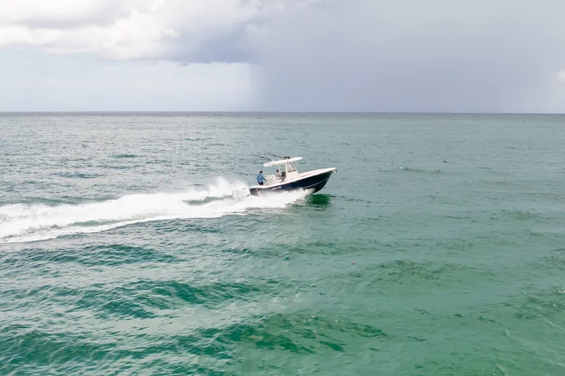 Slide: The Image of 2023 Regulator 28 Forward Seating boat cruising on open ocean waters. - 5