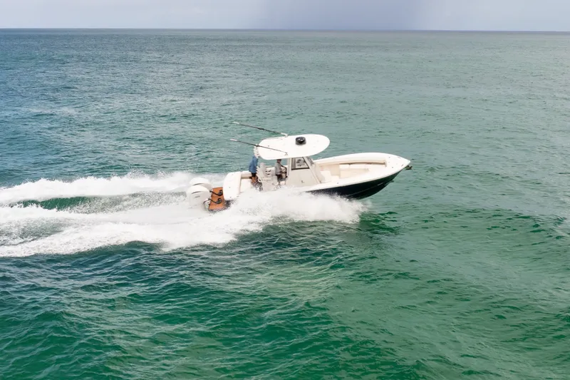 Slide: The Image of 2023 Regulator 28 Forward Seating boat cruising on open water. - 6