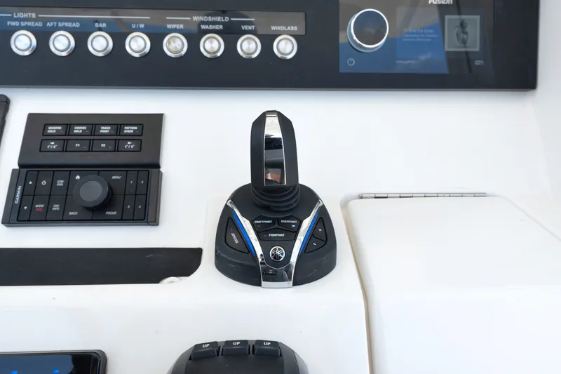 Slide: The Image of Control panel of 2023 Regulator 28 Forward Seating boat with joystick and navigation controls. - 23