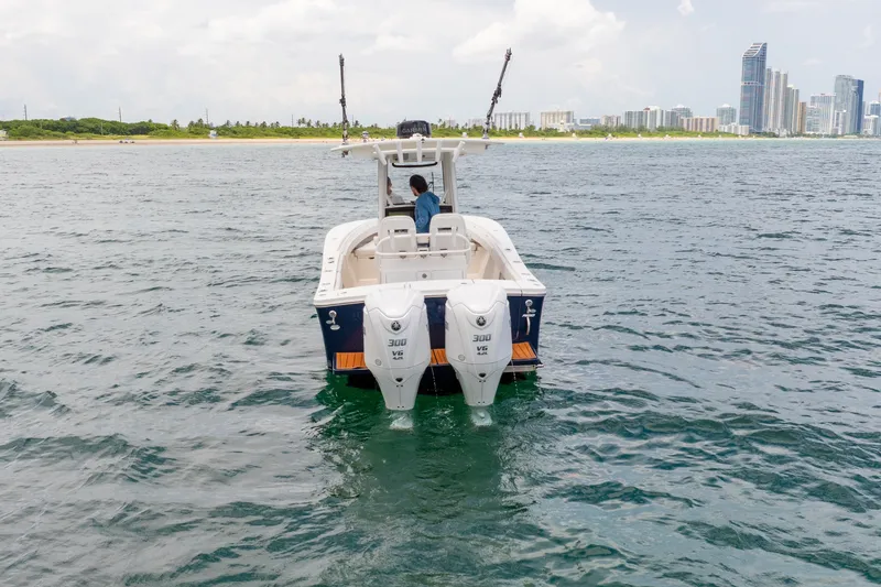 Slide: The Image of 2023 Regulator 28 Forward Seating boat on water near city skyline. - 14