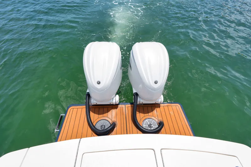 Slide: The Image of 2023 Regulator 28 Forward Seating boat with dual outboard motors on water. - 37