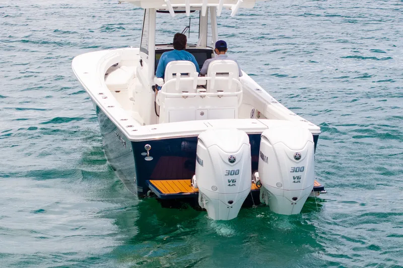 Slide: The Image of 2023 Regulator 28 Forward Seating boat with dual Yamaha 300 engines on the water. - 8