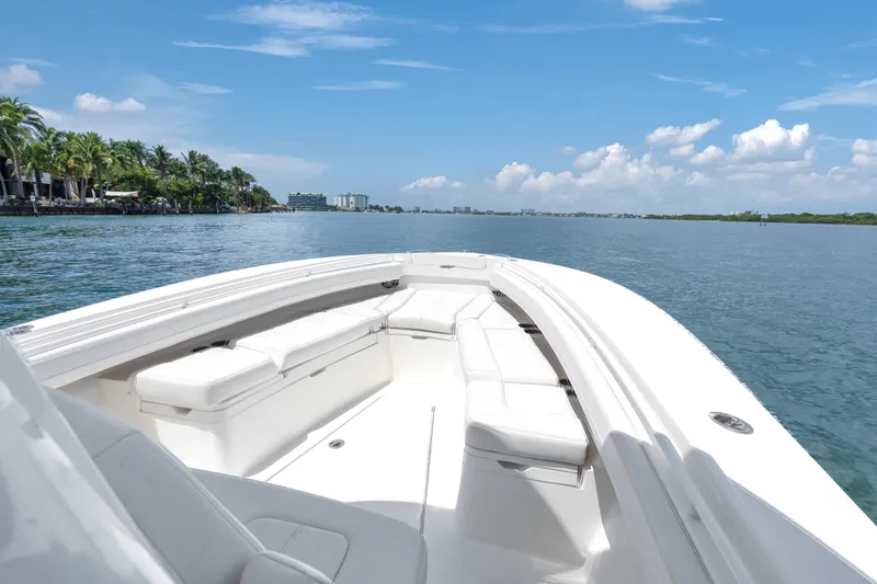 Slide: The Image of 2023 Regulator 28 Forward Seating boat cruising on a sunny day with clear skies. - 34