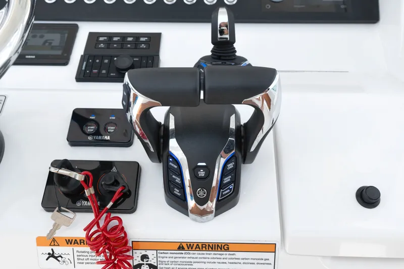 Slide: The Image of Control panel of 2023 Regulator 28 Forward Seating boat with Yamaha throttle and warning labels. - 22