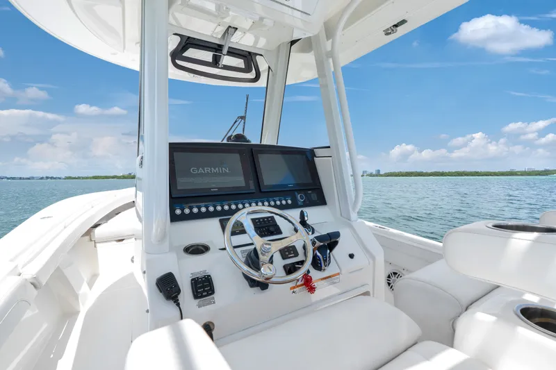 Slide: The Image of 2023 Regulator 28 Forward Seating boat interior with Garmin navigation system on open water. - 18