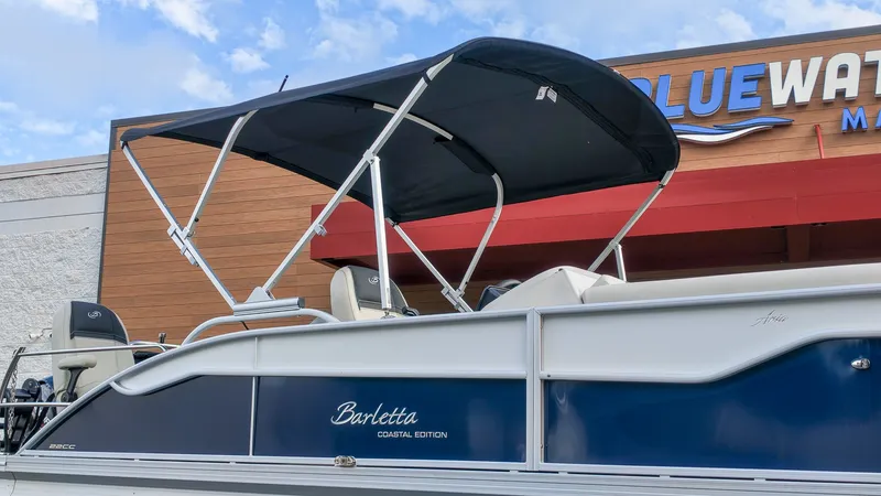 The Image of The image shows a 2027 Barletta Aria 22CC boat with a black sunshade. - 1