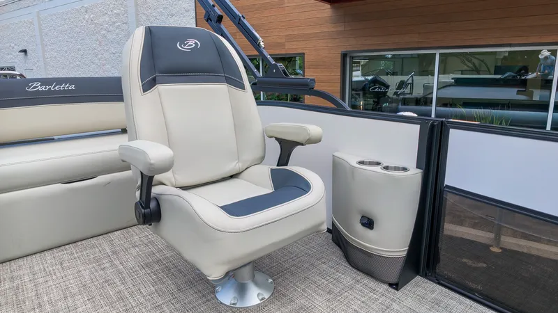 Slide: The Image of A sleek captain's chair with armrests and cup holders on a modern boat. - 14