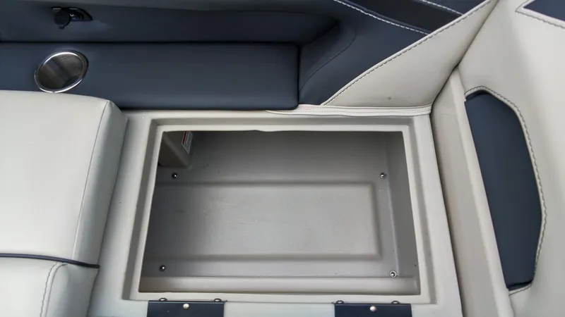 Slide: The Image of An open storage compartment with cushioned seating and a cup holder beside it. - 20