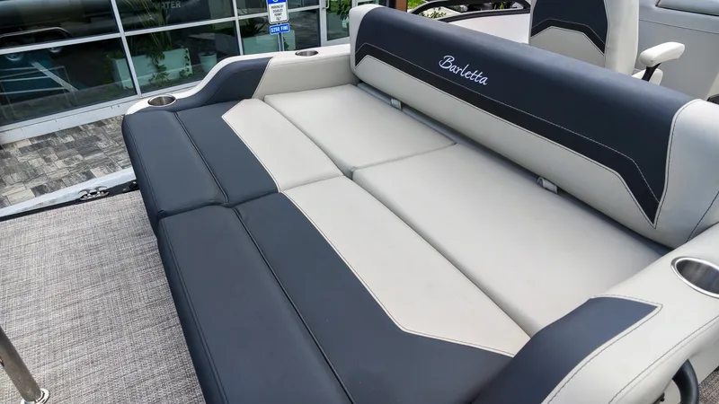 Slide: The Image of The image shows a luxurious seating area on a Barletta Aria 24UC boat. - 9