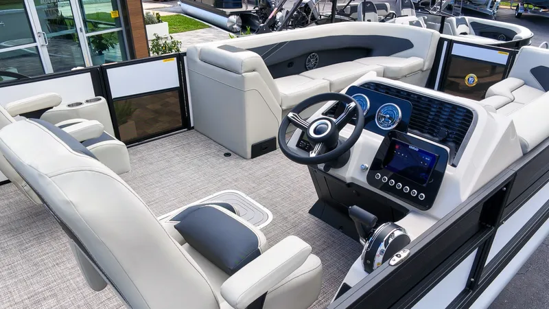Slide: The Image of The image shows the interior of a 2027 Barletta Aria 24UC pontoon boat with sleek seating and a modern helm. - 6