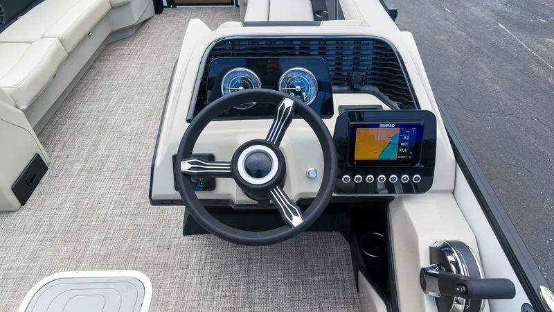 Slide: The Image of The image shows the helm of a Barletta Aria 24UC boat with modern instruments. - 20