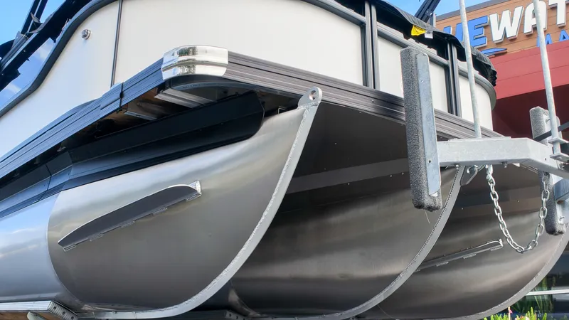 Slide: The Image of Close-up of the hull of a Barletta Aria 24UC pontoon boat on a trailer. - 3